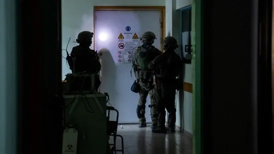**Israeli Forces Order Immediate Evacuation of Al-Shifa Hospital in Gaza** In a dramatic escalation of tensions, Israeli forces issued an urgent directive on Saturday, compelling the immediate evacuation of Al-Shifa hospital in Gaza within the next hour. The order, conveyed to the hospital's director, Mohammed Abu Salmiya, specified the evacuation of patients, the wounded, displaced individuals, and medical staff, emphasizing a journey on foot towards the seafront. **Alleged Hamas Presence Prompts Evacuation Order** This evacuation order follows an incident two days earlier when Israeli troops meticulously combed the hospital, claiming to have unearthed a Hamas tunnel shaft and a vehicle laden with weapons within the complex. The Israeli Defence Forces (IDF) released a video purportedly showing a tunnel entrance in an outdoor area of Gaza's largest hospital, though the video's authenticity remains unverified. **Al-Shifa Hospital Struggles Amidst Ongoing Israel-Hamas Conflict** As the Israel-Hamas conflict enters its seventh week, Al-Shifa hospital finds itself at the forefront of the battle. Plagued by power cuts due to fuel shortages, the hospital has become a symbol of the humanitarian crisis. The Hamas health ministry reports numerous casualties at the hospital, attributing them to power outages. Despite previous evacuation calls by Israel, medical professionals argue that the movement of patients is impractical. Amidst the turmoil, the United Nations discloses that around 2,300 patients, staff, and displaced individuals sought refuge in the hospital before the Israeli incursion on Wednesday. Meanwhile, a doctor from Al-Shifa hospital reveals a dire shortage of food and water, describing the supplies provided by the Israeli military as 